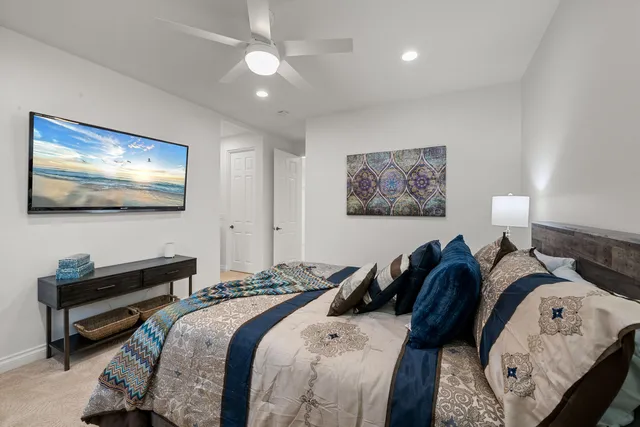 a bed room with two bed and a flat screen tv