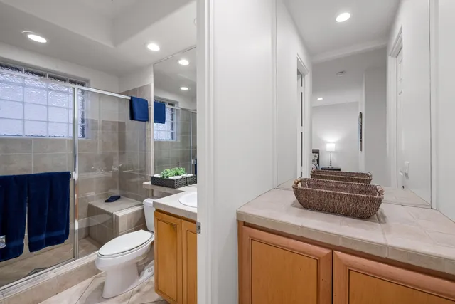 a bathroom with a toilet a sink and a shower