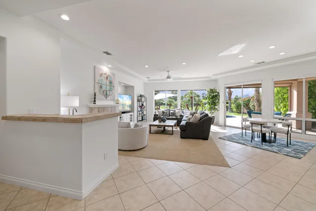 a kitchen with stainless steel appliances kitchen island granite countertop a sink and a counter top space