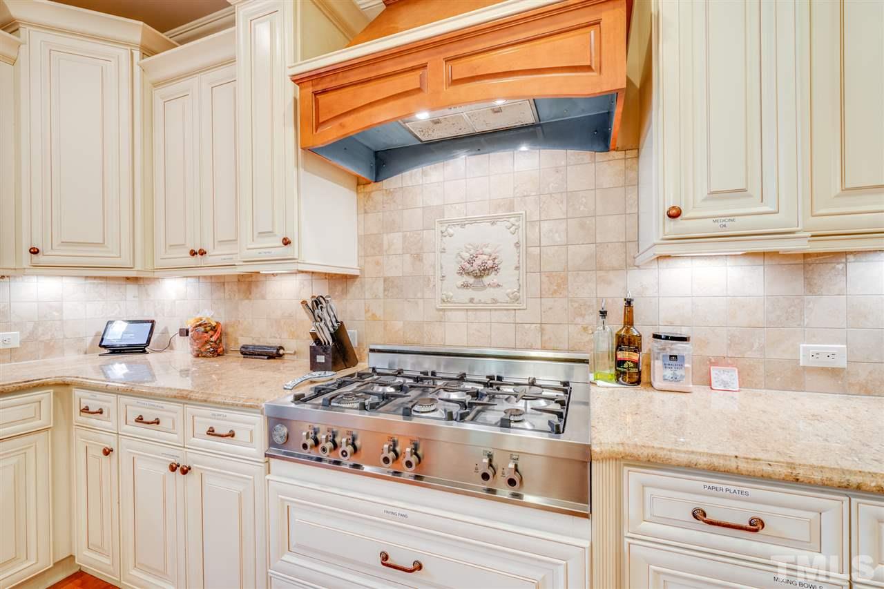 9020 Albatross Court Raleigh, NC 27613 - Photo 14 of 28 a kitchen with white cabinets and appliances