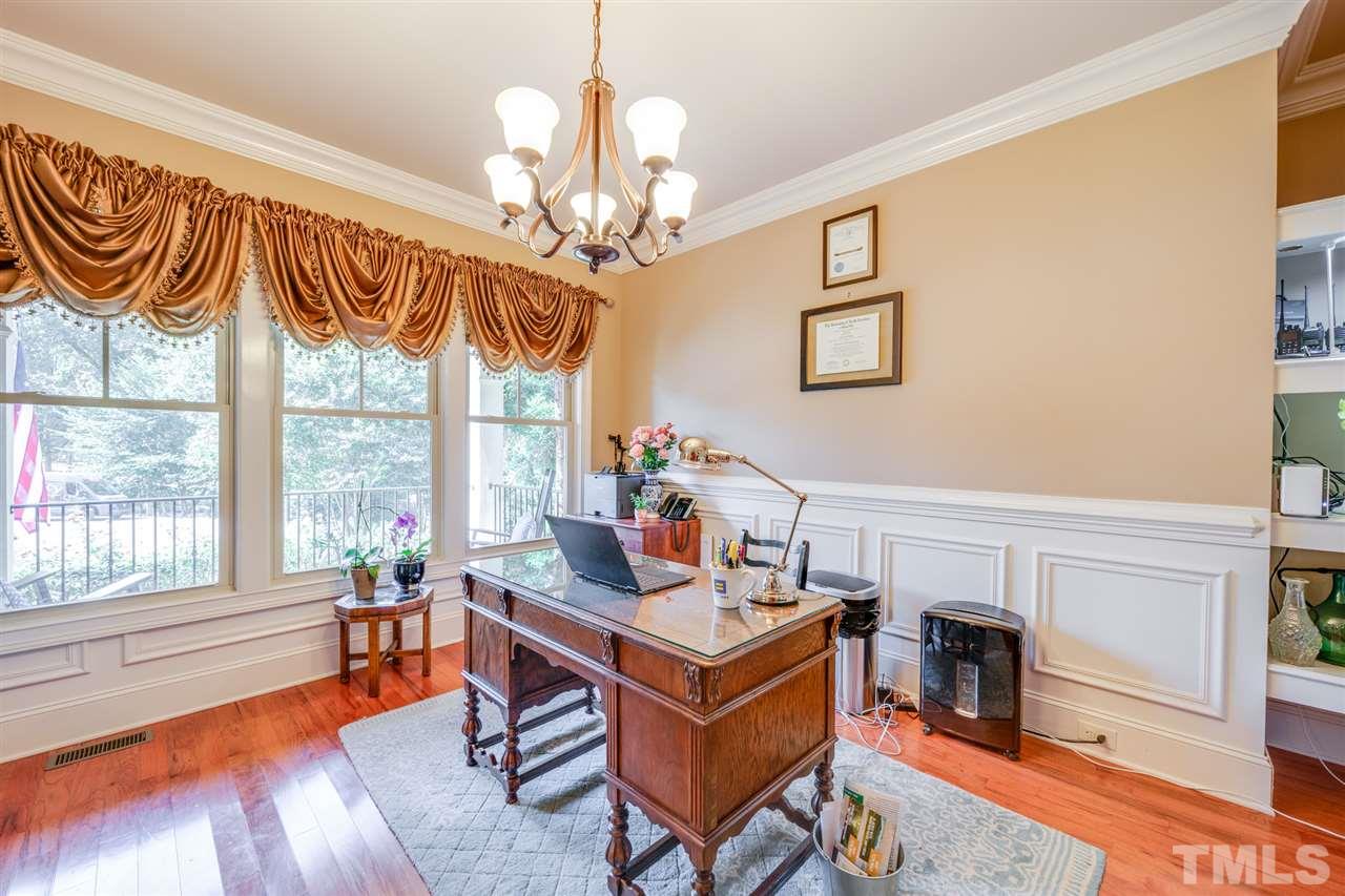 9020 Albatross Court Raleigh, NC 27613 - Photo 8 of 28 a living room with furniture and a chandelier