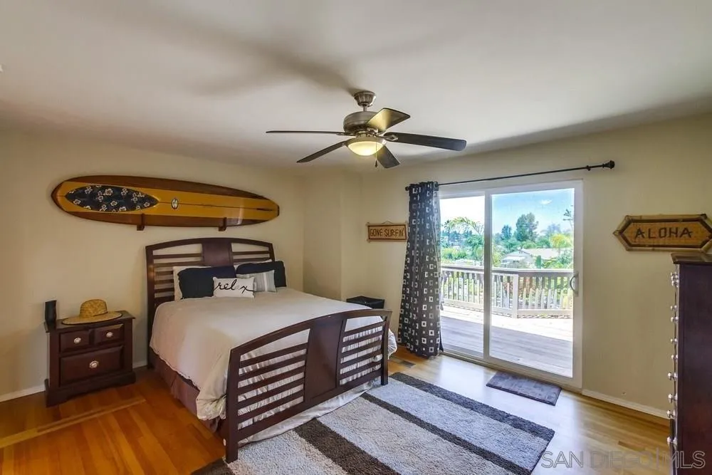 1582 Sunrise Drive Vista, CA 92084 - Photo 12 of 17 a bedroom with a bed and a chandelier