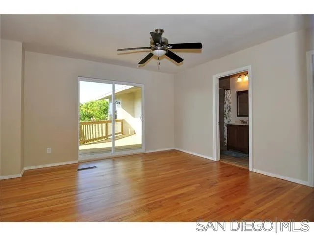 1582 Sunrise Drive Vista, CA 92084 - Photo 13 of 17 a view of an empty room with wooden floor and a window