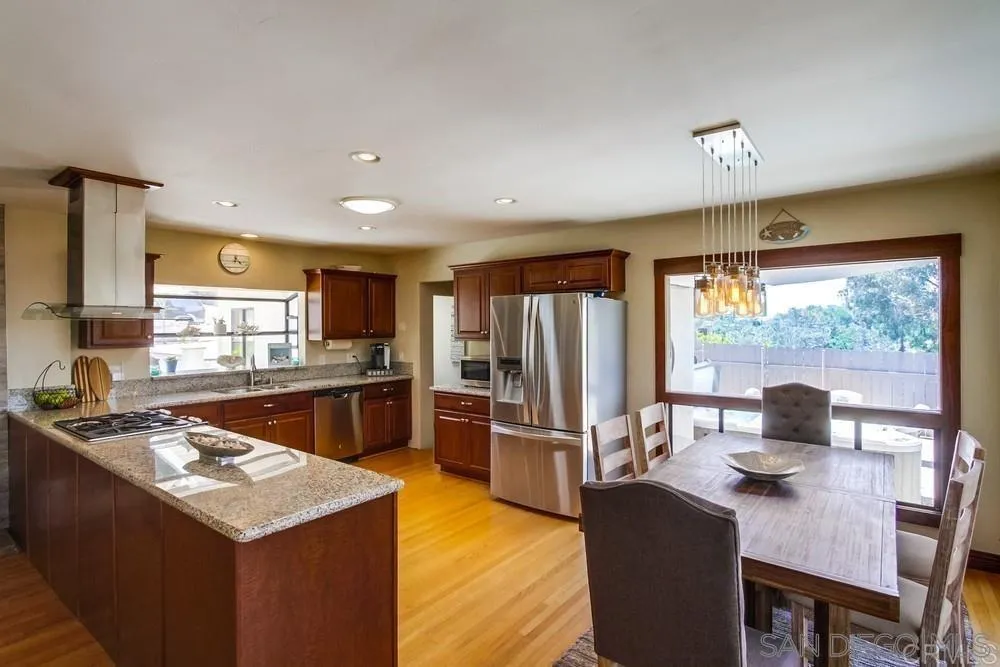1582 Sunrise Drive Vista, CA 92084 - Photo 6 of 17 a kitchen with stainless steel appliances granite countertop a sink stove and refrigerator