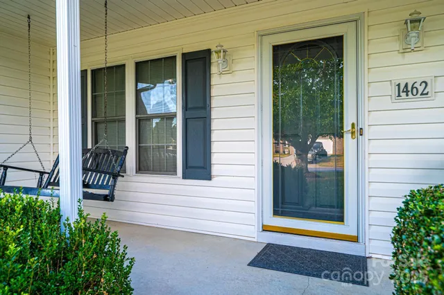 a view of porch with a bench and potted plants