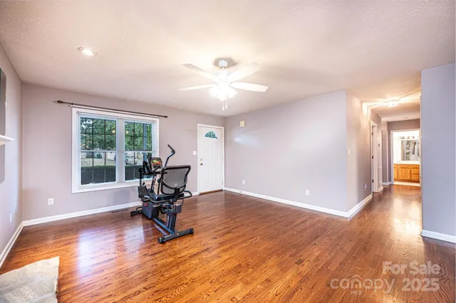 a view of a room with gym equipment and a window
