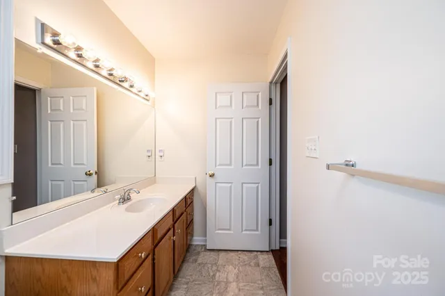 a bathroom with a sink a mirror and a shower