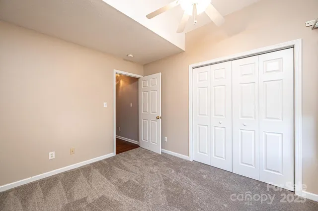 an empty room with windows and outdoor view