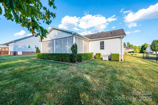a view of a house with backyard and a garden