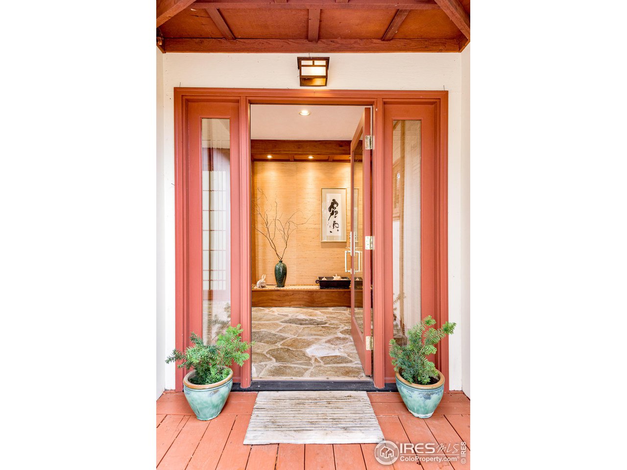 7845 Baseline Road Boulder, CO 80303 - Photo 1 of 40 a view of a hallway with wooden floor and a potted plant