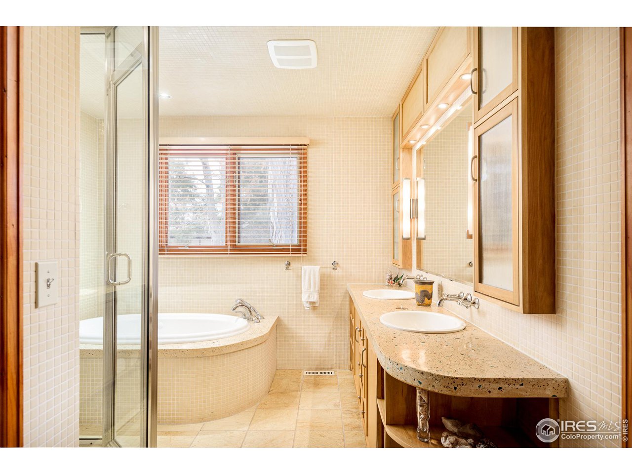 7845 Baseline Road Boulder, CO 80303 - Photo 9 of 40 a bathroom with a granite countertop sink a mirror and a bathtub