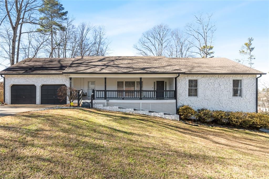 1581 Greers Chapel Road Northwest Kennesaw, GA 30152 - Photo 1 of 1 a front view of a house with a yard