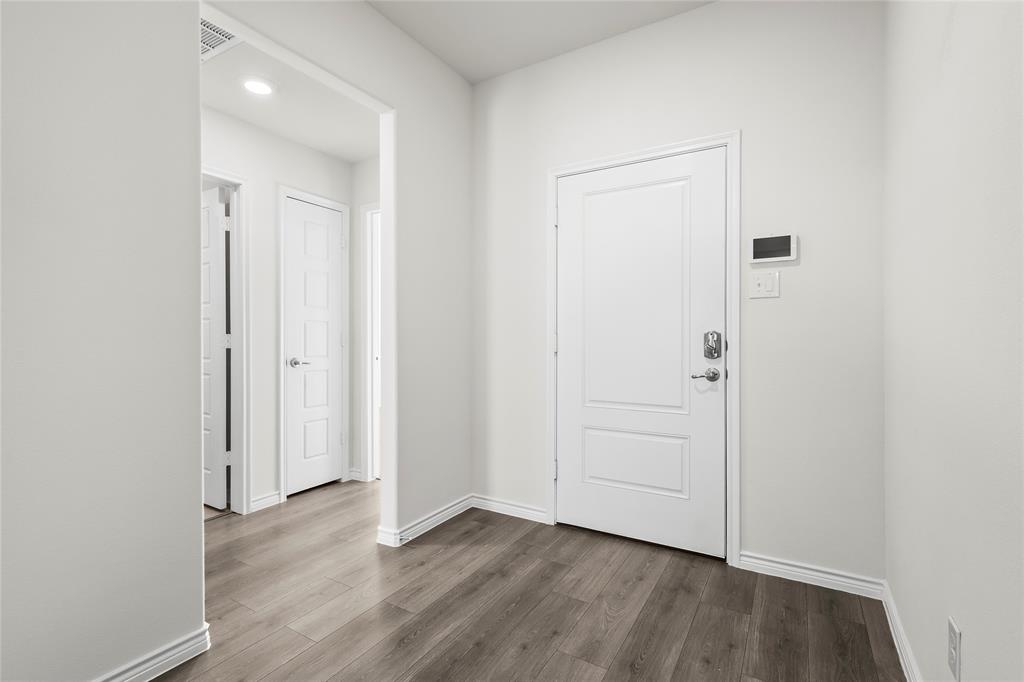 812 Indigo Road Princeton, TX 75407 - Photo 11 of 28 a view of an empty room and wooden floor