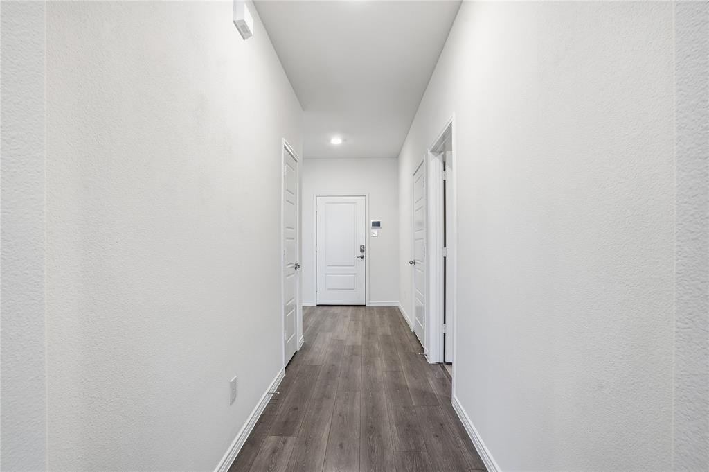 812 Indigo Road Princeton, TX 75407 - Photo 13 of 28 a view of a hallway with wooden floor
