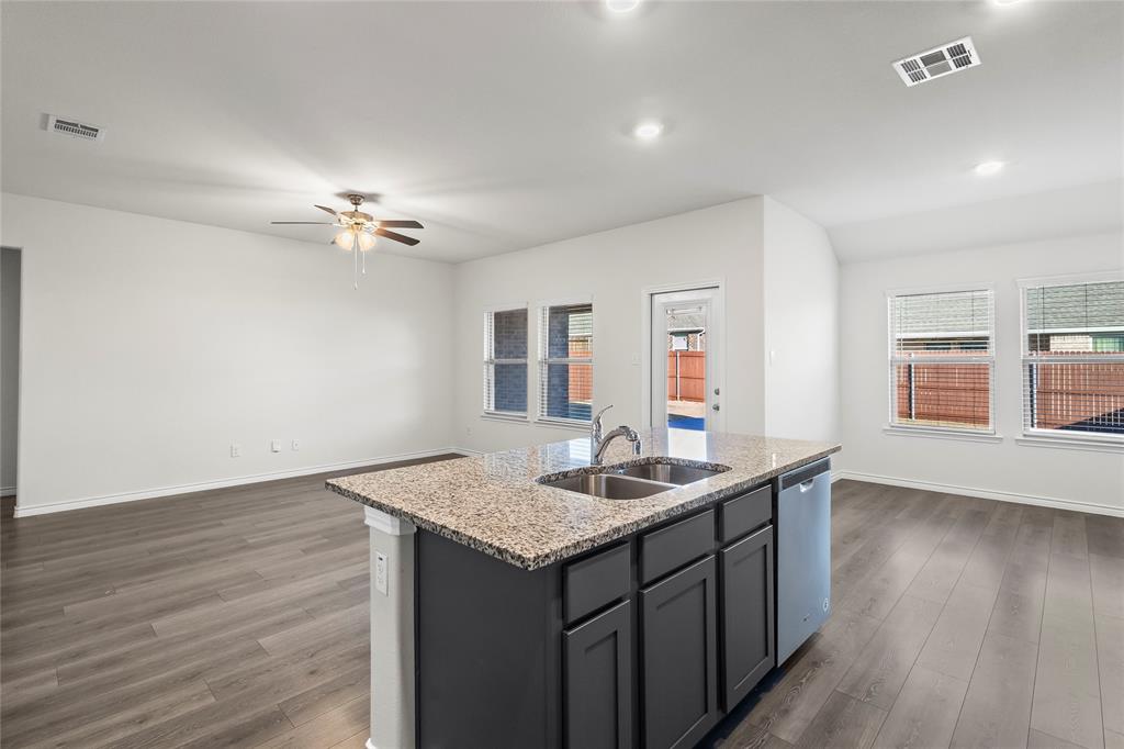 812 Indigo Road Princeton, TX 75407 - Photo 23 of 28 a kitchen with a sink and chandelier