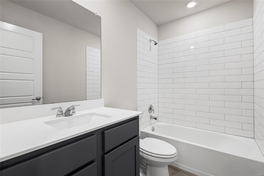 812 Indigo Road Princeton, TX 75407 - Photo 9 of 28 a bathroom with a sink a toilet and a bathtub