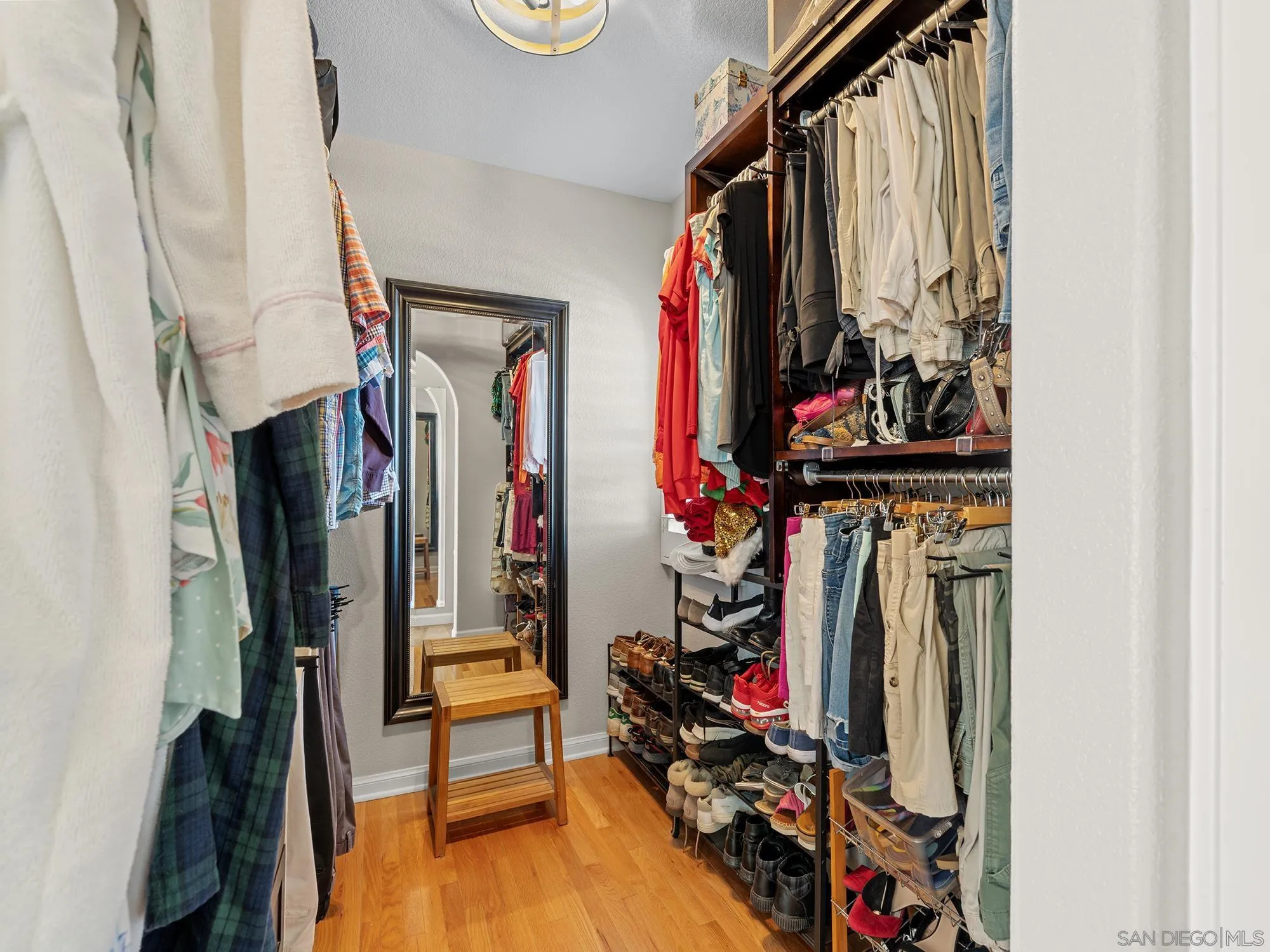 4385 Orchard Avenue San Diego, CA 92107 - Photo 25 of 55 a view of walk in closet with clothes