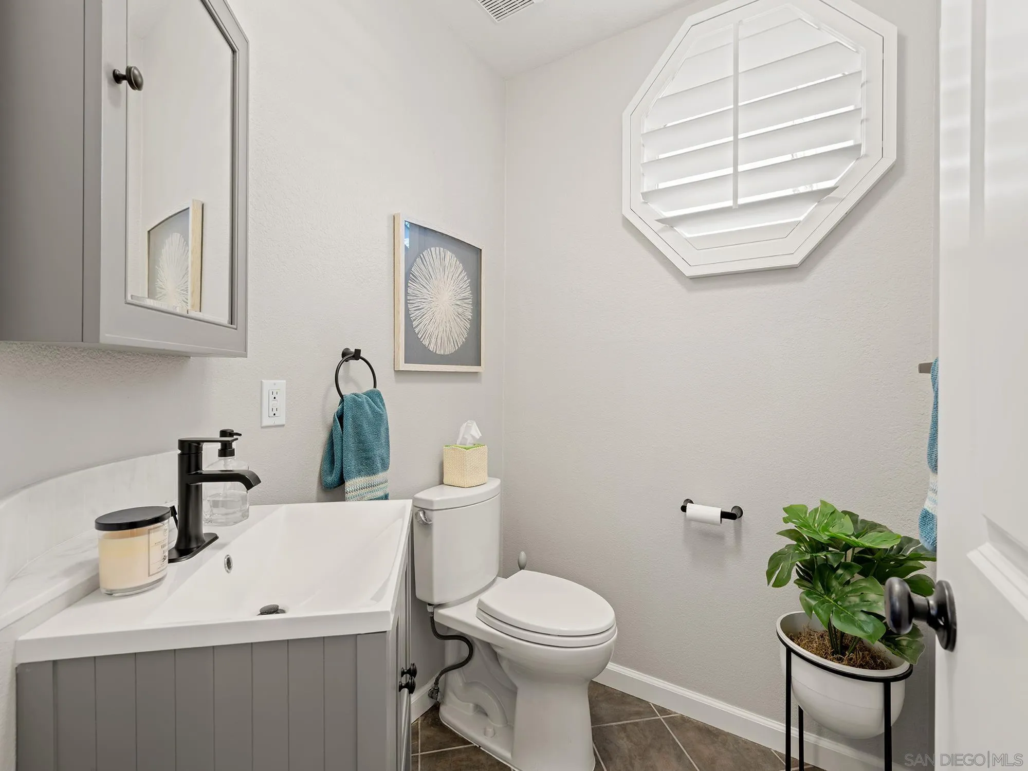 4385 Orchard Avenue San Diego, CA 92107 - Photo 30 of 55 a bathroom with a toilet a sink and a window