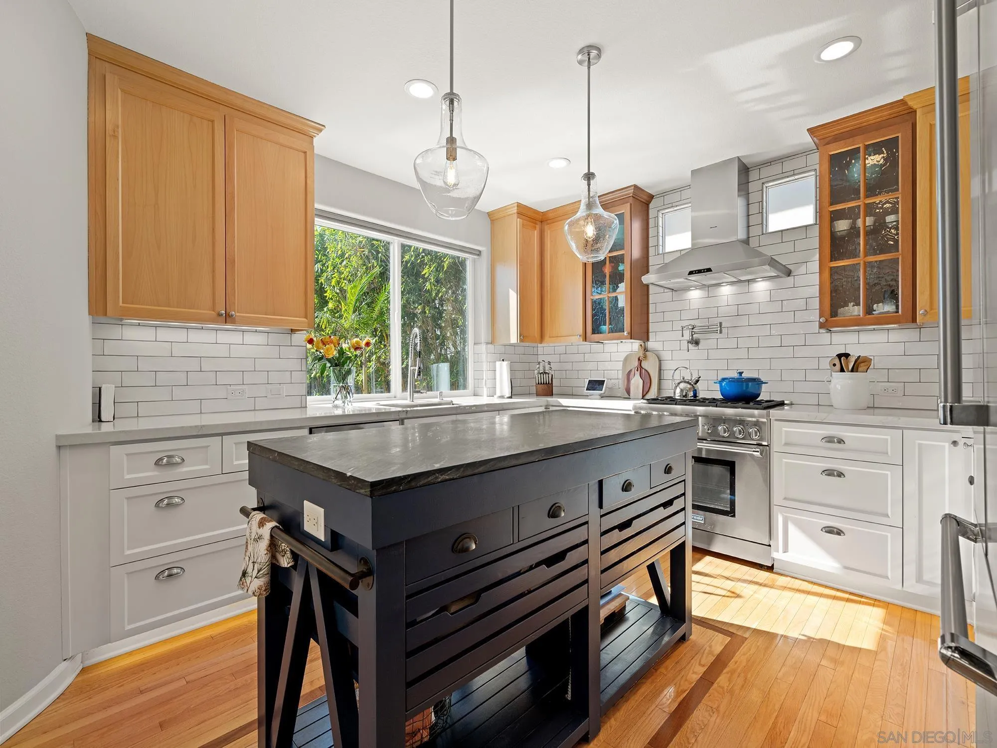 4385 Orchard Avenue San Diego, CA 92107 - Photo 3 of 55 a kitchen with stainless steel appliances granite countertop a stove and a sink