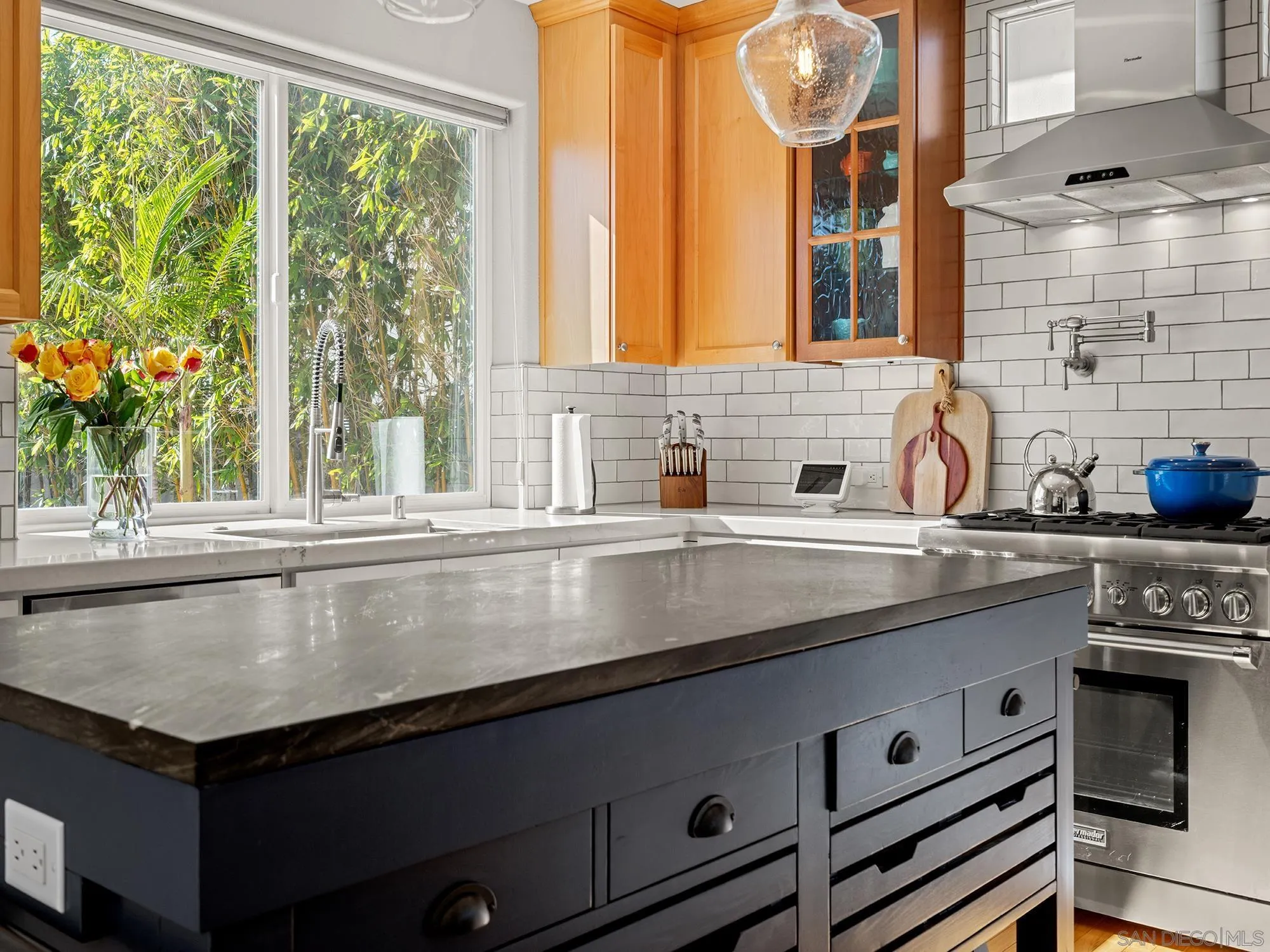 4385 Orchard Avenue San Diego, CA 92107 - Photo 8 of 55 a kitchen with a sink and a large mirror next to a window