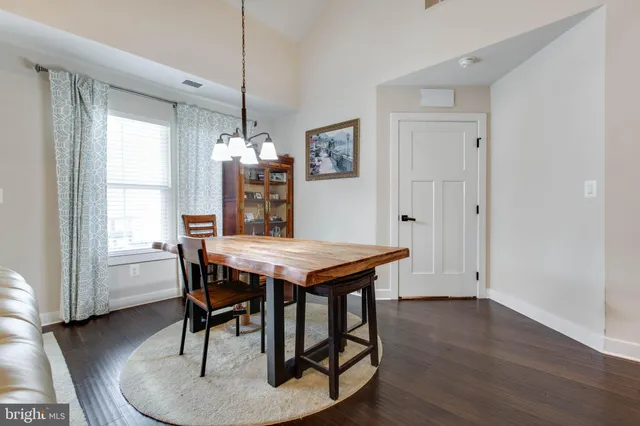 a dining room with furniture window and wooden floor