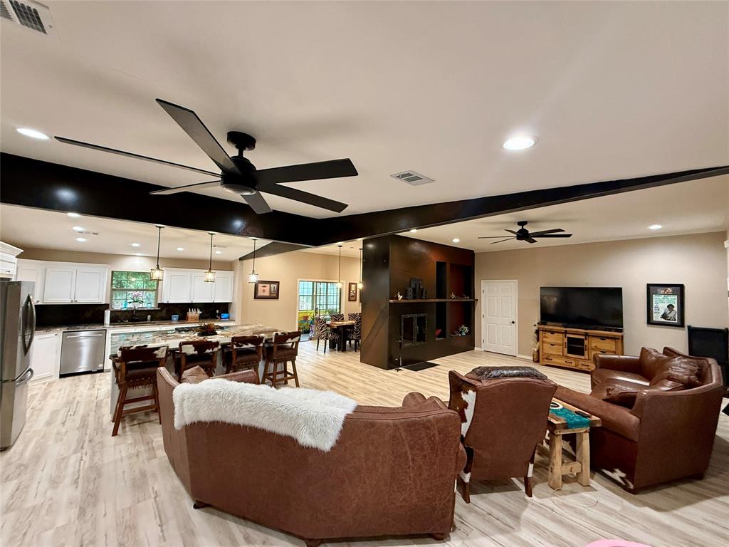 2007 Deep Water Road May, TX 76857 - Photo 6 of 40 a living room with fireplace furniture and a flat screen tv