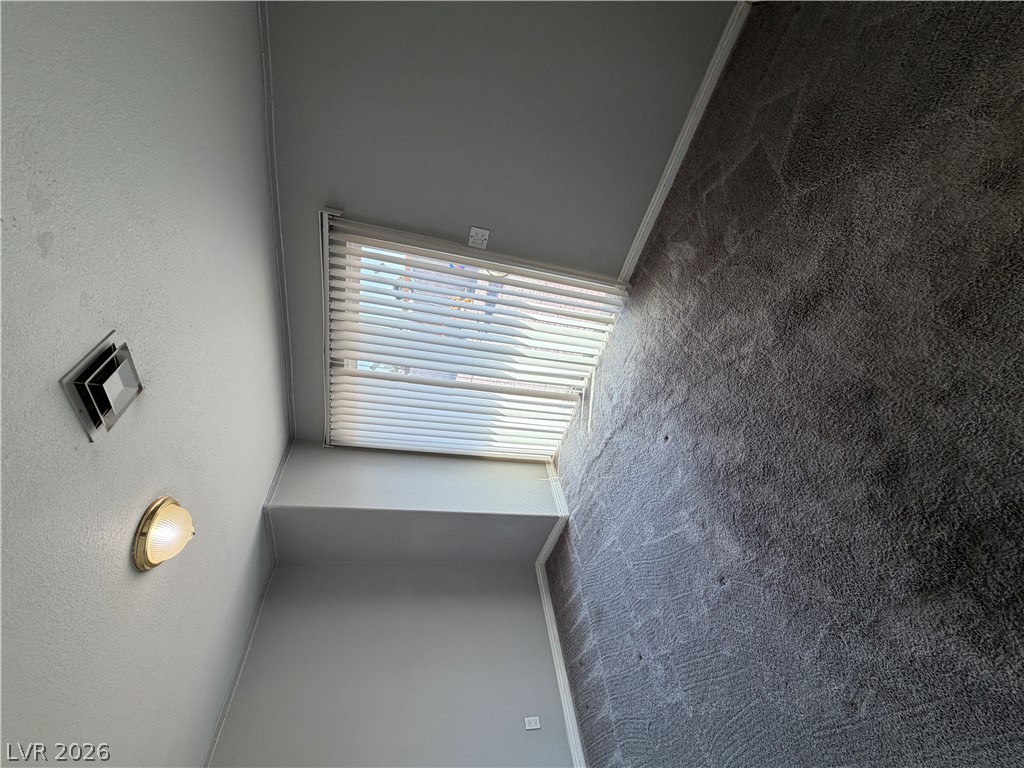 2820 South Sandhill Road, Unit A Las Vegas, NV 89121 - Photo 14 of 26 Sun-filled room featuring plush wall-to-wall carpeting and natural light filtering through window blinds.