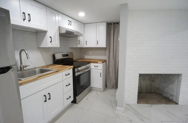 a kitchen with cabinets appliances and a sink