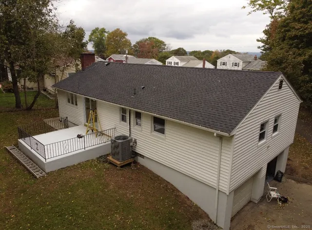 an aerial view of a house with a yard
