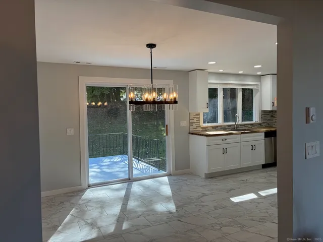 a open kitchen with a sink and refrigerator