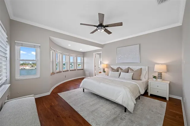 a bedroom with a large bed and a chandelier