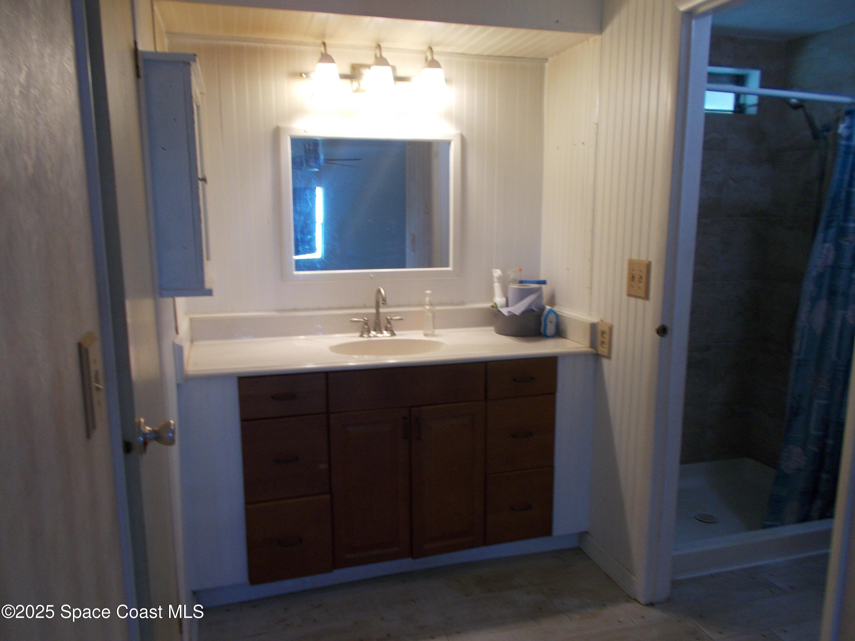 906 Spruce Street Sebastian, FL 32976 - Photo 13 of 26 a bathroom with a sink and a mirror