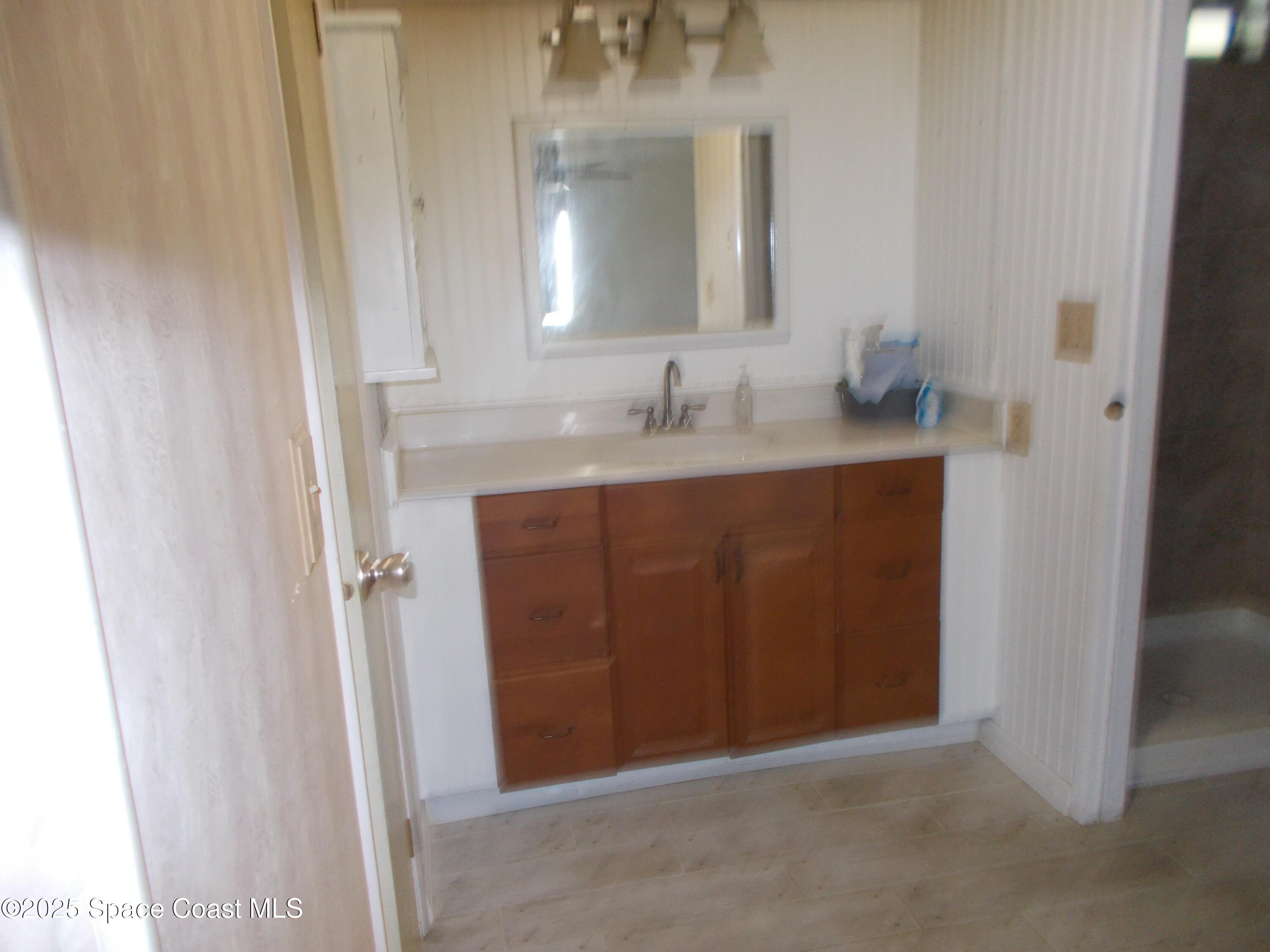 906 Spruce Street Sebastian, FL 32976 - Photo 16 of 26 a bathroom with a sink and a mirror