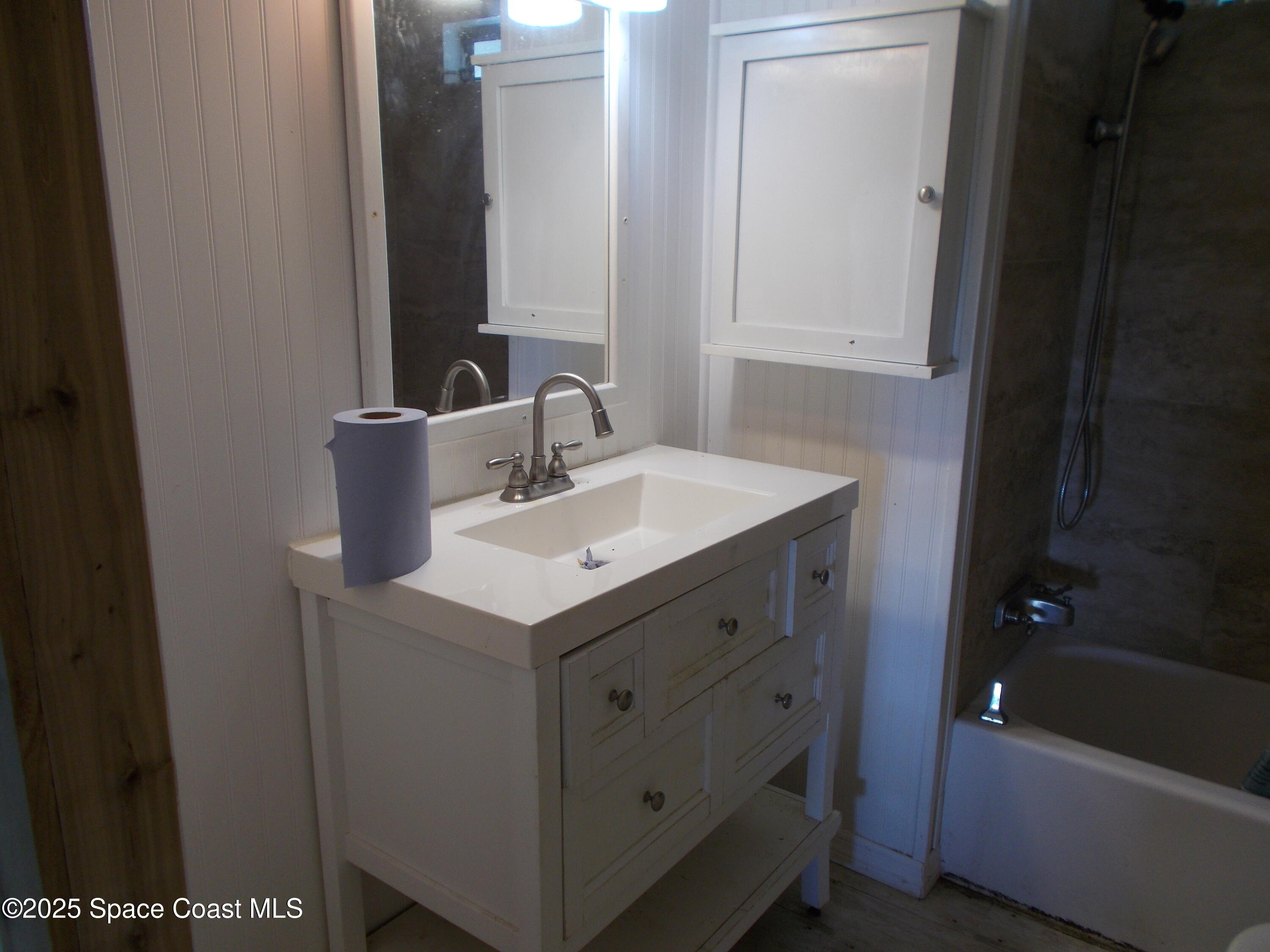 906 Spruce Street Sebastian, FL 32976 - Photo 18 of 26 a bathroom with a sink and a mirror