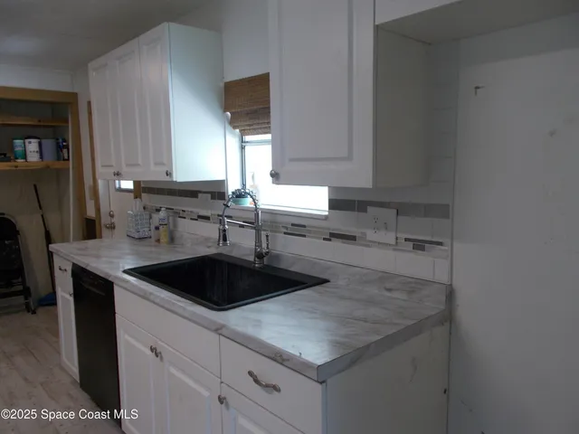 a kitchen with a sink and cabinets