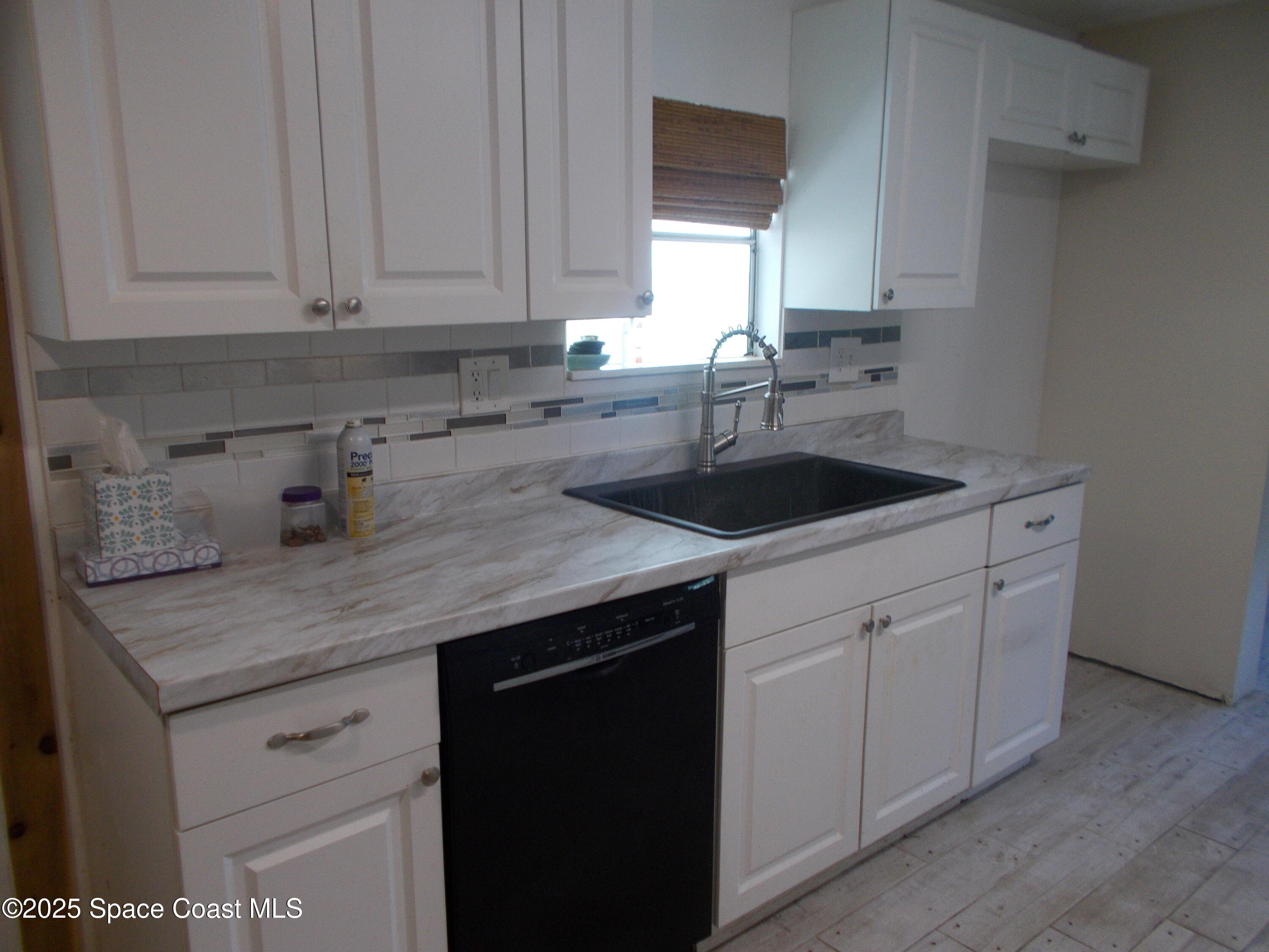 906 Spruce Street Sebastian, FL 32976 - Photo 4 of 26 a kitchen with a sink dishwasher and cabinets