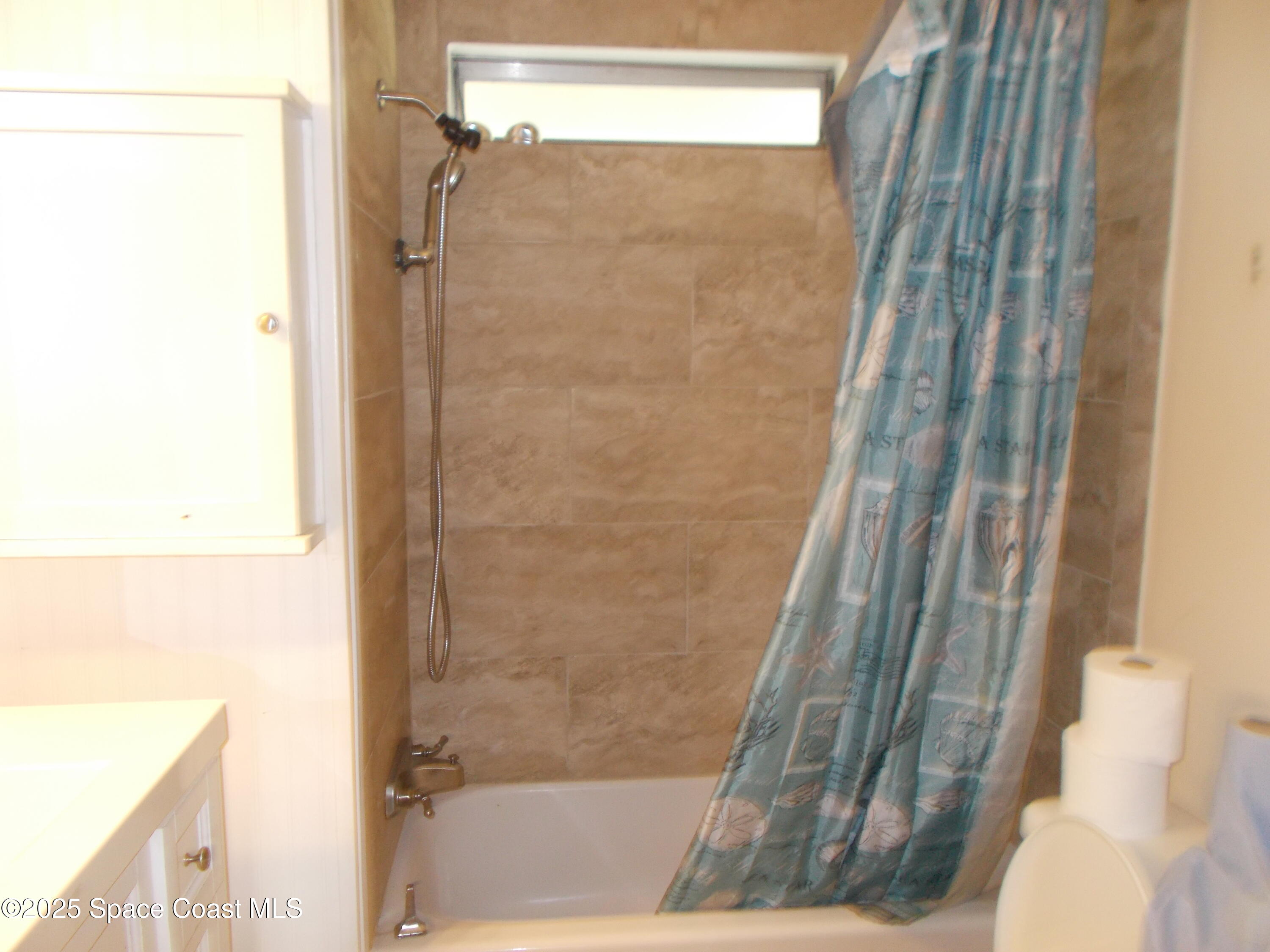 906 Spruce Street Sebastian, FL 32976 - Photo 10 of 26 a bathroom with a shower and a toilet