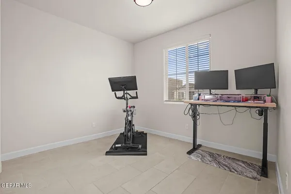 a room with gym equipment and a flat screen tv