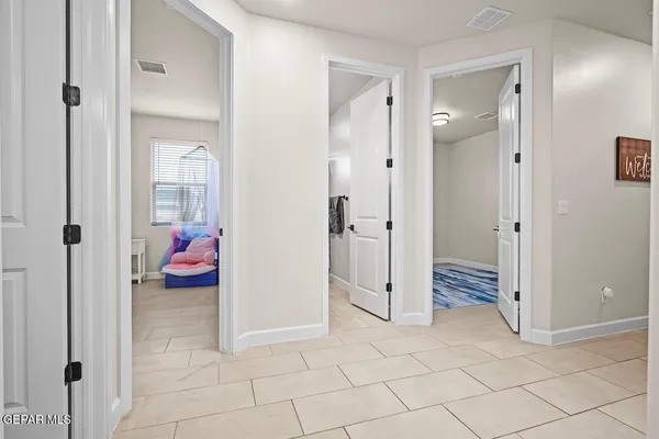 a view of a room with wooden floor and a window