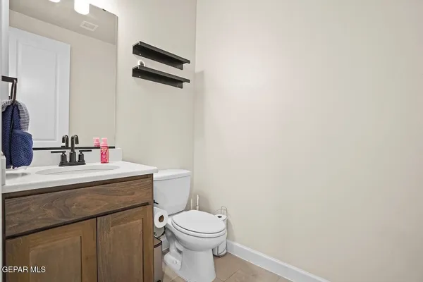 a bathroom with a sink a toilet a mirror and shower