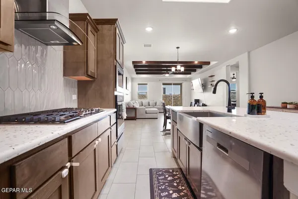 a living room with furniture and kitchen view