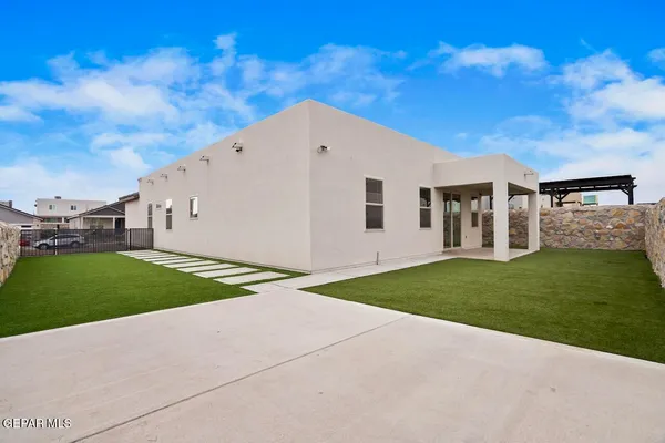 a view of a white house with a yard