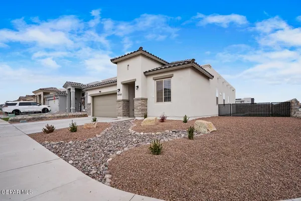 a backyard of a house with dishwasher and wooden fence