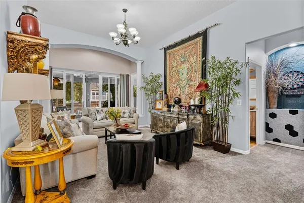 a living room with furniture and a chandelier