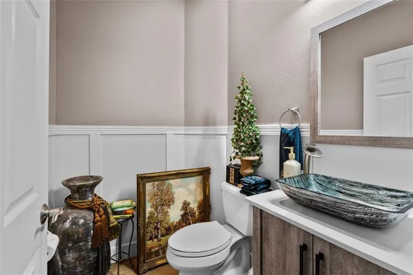 a kitchen with stainless steel appliances granite countertop a refrigerator a stove top oven a sink a dining table and chairs