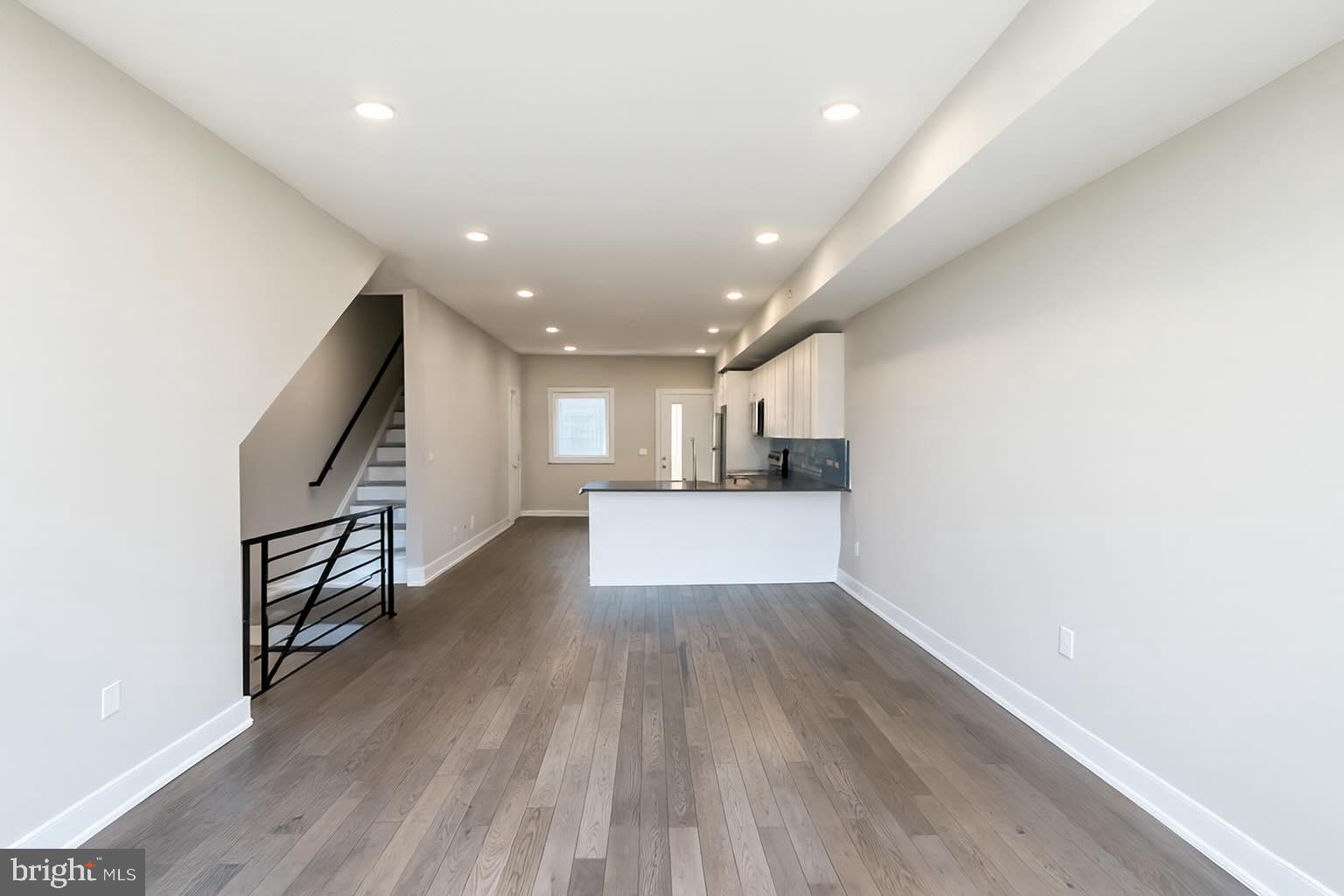 1407 North 8th Street, Unit A2 Philadelphia, PA 19122 - Photo 3 of 14 a view of livingroom with wooden floor