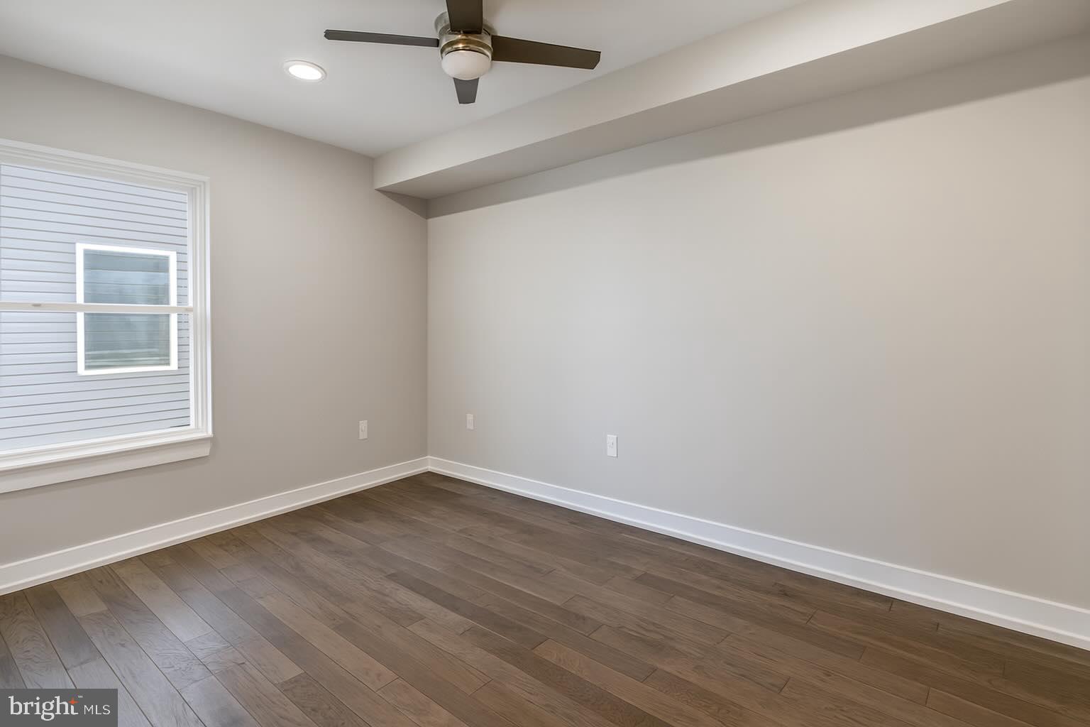 1407 North 8th Street, Unit A2 Philadelphia, PA 19122 - Photo 4 of 14 wooden floor in an empty room with a window