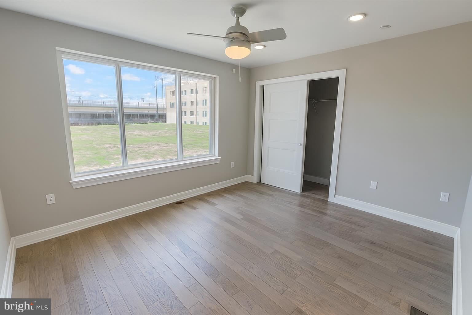 1407 North 8th Street, Unit A2 Philadelphia, PA 19122 - Photo 5 of 14 a view of an empty room with wooden floor and a window
