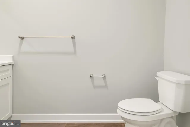 a white toilet sitting next to a bath tub