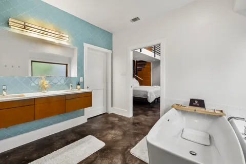 a bathroom with a toilet sink and mirror